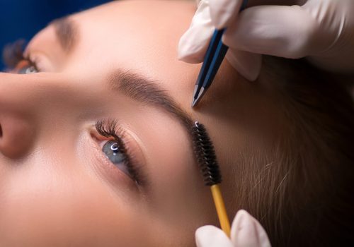 Beautician plucking eyebrows. Eyebrow care in a beauty salon